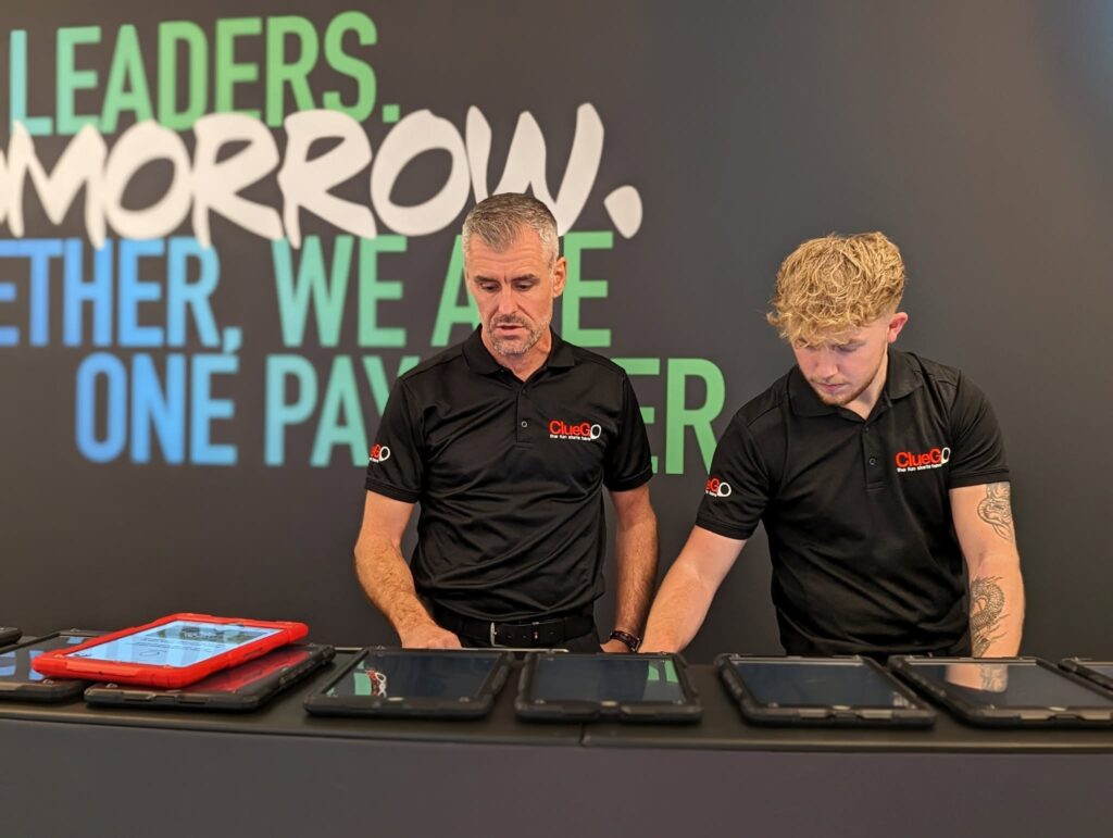 Mooveteam partner facilitators preparing rugged tablets before delivering a corporate gamified event.